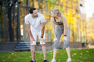 Fitness. Personal Trainer Takes Notes While Woman Exercising Outdoor