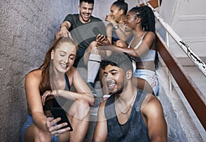 Fitness, phone and group of friends on stairs networking on social media together after gym workout. Happy, smile and