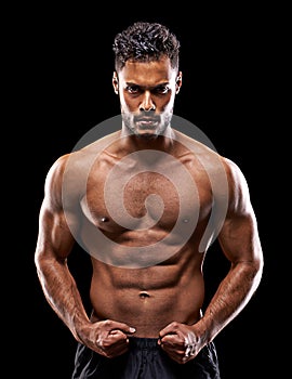 Fitness, portrait and man in studio with muscle, confidence and workout routine in health, wellness and power. Flexing