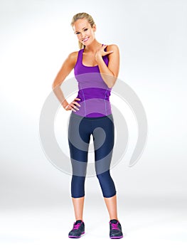 Fitness, portrait and woman in studio with activewear, happiness and healthy body. Exercise, wellness and girl on white