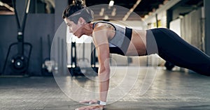 Fitness, power and woman doing a pushup in the gym for a health, wellness and strength workout. Sports, training and