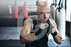 Fitness, punching and man in gym for exercise, boxing challenge or competition training. Power, muscle and champion