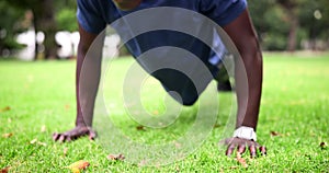 Fitness, push up and black man in park for morning workout in garden with grass, action and sweat. Health, wellness and