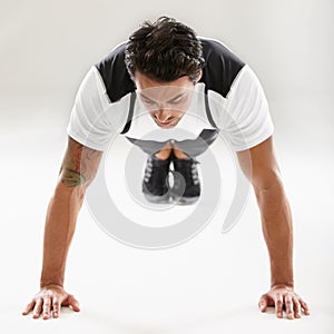 Fitness, push ups or sports man training in studio for muscle or strong arms on floor in exercise. Power, white