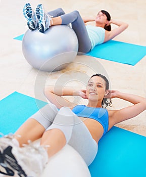 Fitness, pushup and women with exercise ball on gym floor for training, wellness and cardio routine. Pilates, workout