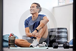 Fitness, relax or happy sports man at gym after training, workout or exercise resting on a break. Tired, smile or