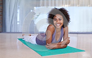 Fitness, relax and portrait of black woman on mat in home for yoga, exercise and body care. Smile, wellness and girl