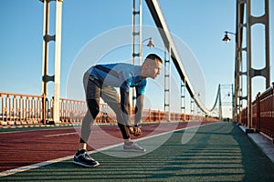 Fitness runner doing warm-up routine before running