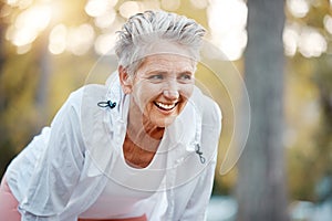 Fitness, running and park with a senior woman athlete outdoor in nature for exercise or cardio training. Tired, rest and