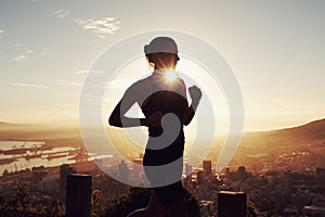 Fitness, running and woman in silhouette on mountain for health, wellness and strong body development. Workout, exercise