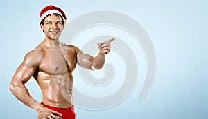 Fitness Santa Claus , show index finger and smile, on blue