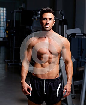 Fitness shaped muscle man posing on gym