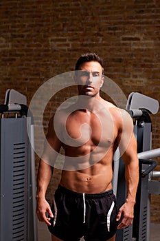 Fitness shaped muscle man posing on gym