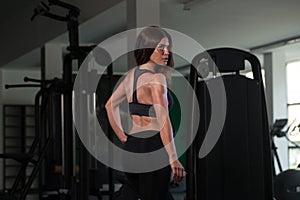 Fitness Shaped Muscle Woman Posing In Dark Gym