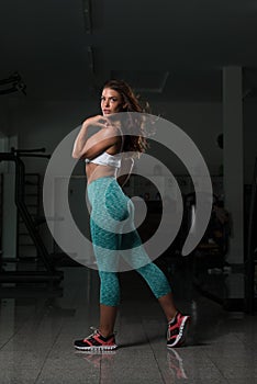 Fitness Shaped Muscle Woman Posing In Dark Gym