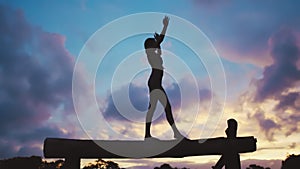 Fitness, silhouette and woman on balance beam against a night sky for exercise and training. Yoga, outline and shadow of