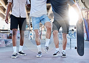 Fitness, skateboard and legs of friends at a skatepark in a city for training, sports and summer fun. Shoes, men and