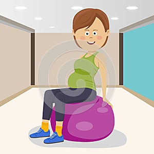 Fitness smiling woman sitting on pink fitness ball in a gym