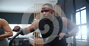 Fitness, spin class and black man in gym for exercise, intense workout and training for health. Sports, cardio machine