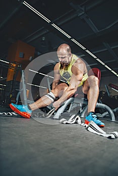 Fitness and Sport. Athletic man bodybuilder preparing for training.