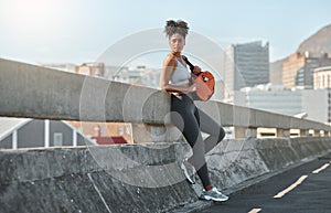 Fitness, sport and black woman in urban city after exercise, relax and break with workout and training. Sports