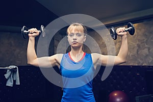 Fitness. Sport concept. Workout. Blonde girl holds black dumbbells. Fitness girl. Healthy lifestyle. Training. Workout. Woman hold