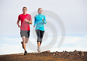 Fitness sport couple running jogging outside on trail