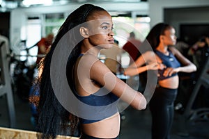 Fitness, sport, dance and lifestyle concept - beautiful black african american woman training in gym or studio