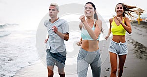 Fitness, sport, friendship and healthy lifestyle concept . Group of happy people jogging