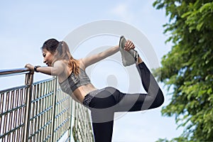 Fitness sport girl fashion sportswear doing yoga fitness exercise in street.