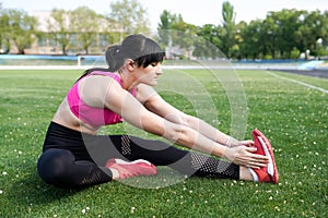 Fitness sport girl in fashion sportswear doing yoga fitness exercise in the street, outdoor sports