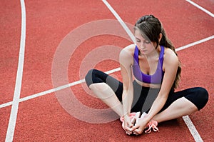 Fitness sport girl in fashion sportswear doing yoga fitness exercise in the street, outdoor sports, urban style.