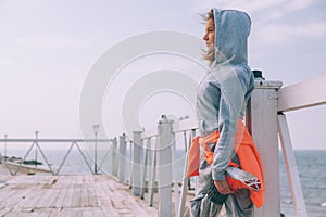 Fitness sport girl in fashion sportswear doing yoga fitness exercise in the street by sea