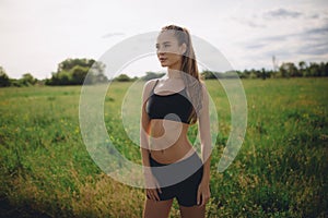 Fitness sport girl runner taking break after jogging outdoors