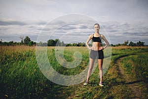 Fitness sport girl runner taking break after jogging outdoors photo