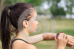 Fitness sport girl woman checks timer during workout training