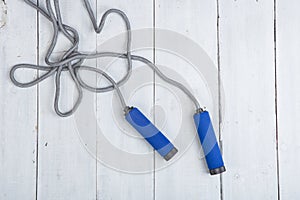 Fitness/sport and healthy lifestyle concept - Jumping/skipping rope with blue handles
