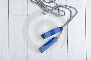 Fitness/sport and healthy lifestyle concept - Jumping/skipping rope with blue handles