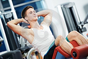 Fitness and sport. man doing abdominal muscles exercises in gym