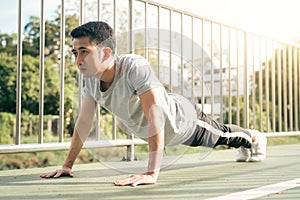 Fitness sport men fashion sportswear doing yoga fitness exercise in street. Fit young asian man doing training workout.
