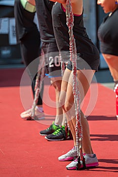 Fitness and Sport: People Exercising with Elastic Cords outdoor at Gym