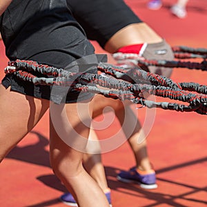 Fitness and Sport: People Exercising with Elastic Cords outdoor at Gym