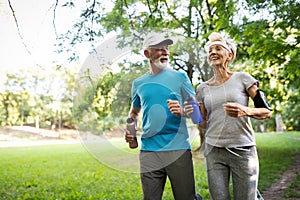 Fitness, sport, people, exercising and lifestyle concept - senior couple running