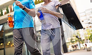 Fitness, sport, people, exercising and lifestyle concept - senior couple running