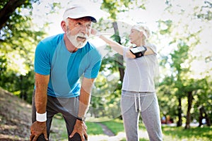 Fitness, sport, people, exercising and lifestyle concept - senior couple running