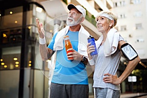 Fitness, sport, people, exercising and lifestyle concept - senior couple running