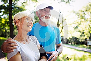 Fitness, sport, people, exercising and lifestyle concept - senior couple running