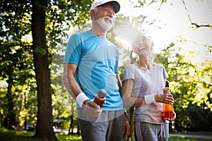 Fitness, sport, people, exercising and lifestyle concept - senior couple running