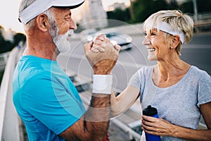 Fitness, sport, people, exercising and lifestyle concept - senior couple running