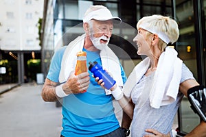 Fitness, sport, people, exercising and lifestyle concept - senior couple running